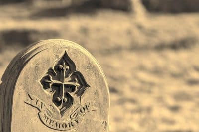 Ancestry and genealogy. Monochrome Ancient gravestone inscribed with in memory of. Tracing a family tree using old cemetery headstones. Antique dye sepia monochrome image with with copy space.
